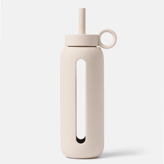 Beige water bottle with a straw on a white background