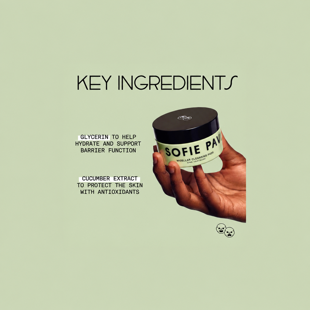 A hand holding a jar of Sofie Pavé facial cleanser against a pale sage green background with text highlighting key ingredients: glycerin and cucumber extract.