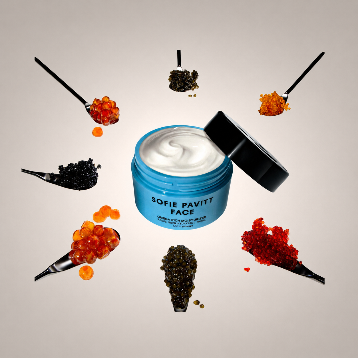 A blue jar of Sofie Pavitt Face Deep Repairing Mask with white cream visible inside, shown with its black lid leaning open. The jar is surrounded by six black spoons holding caviar spheres in red, orange, and black, arranged symmetrically on a light beige background.