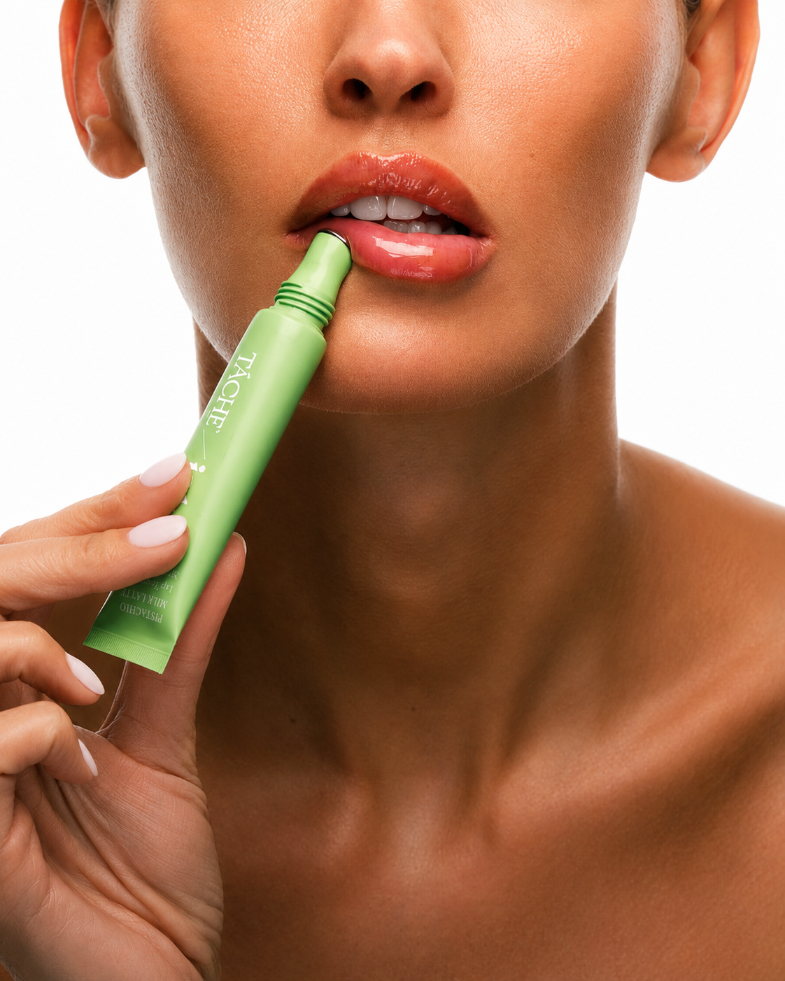 A close-up of a woman holding a light green lip balm tube against her lips, showing the brand name 'PUSH' on the tube, set against a clean white background.