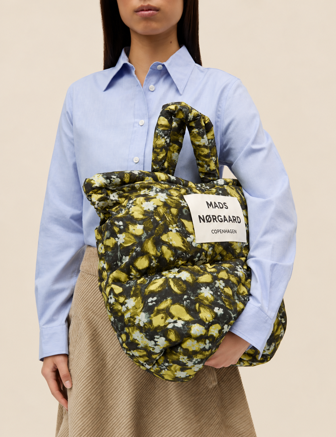 Mads Nørgaard Flora AOP floral puffer tote styled as an oversized everyday shoulder bag.